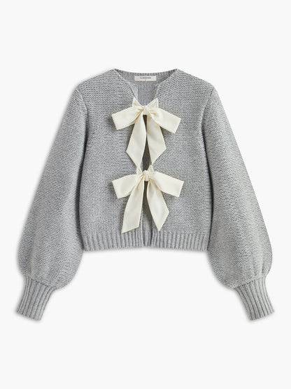 Women's knit top with bow accent and structured silhouette