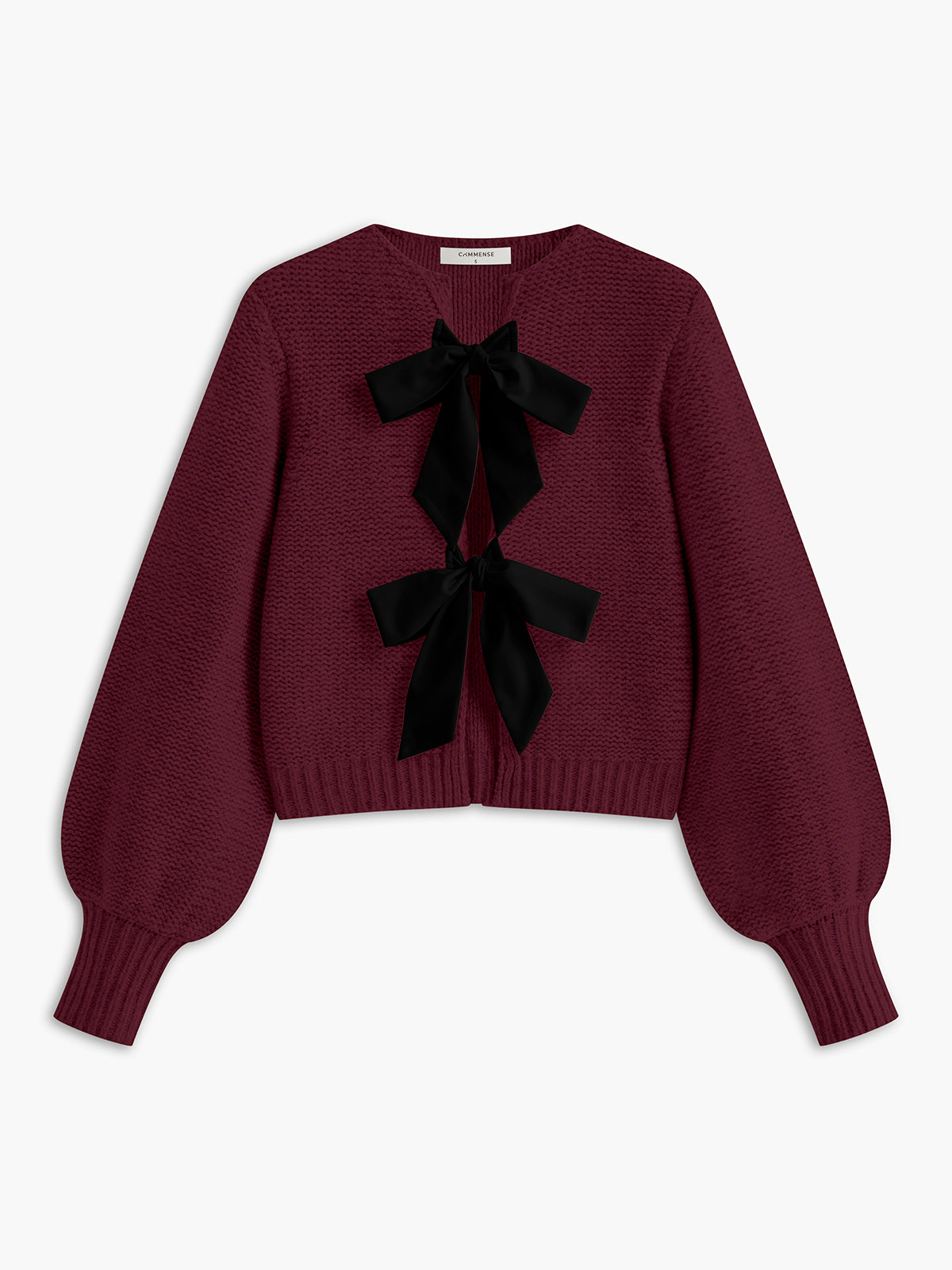 Women's knit top with bow accent and structured silhouette