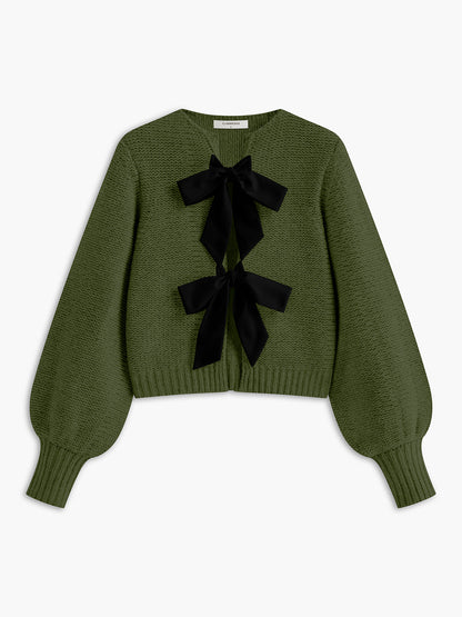 Women's knit top with bow accent and structured silhouette