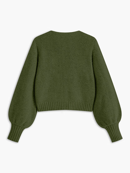 Women's knit top with bow accent and structured silhouette