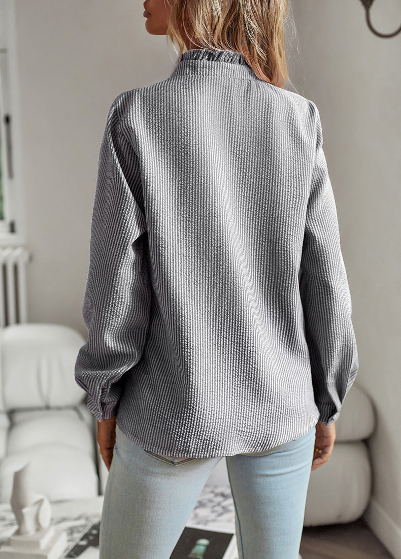 Women's blouse with ruffle accents and clean button front