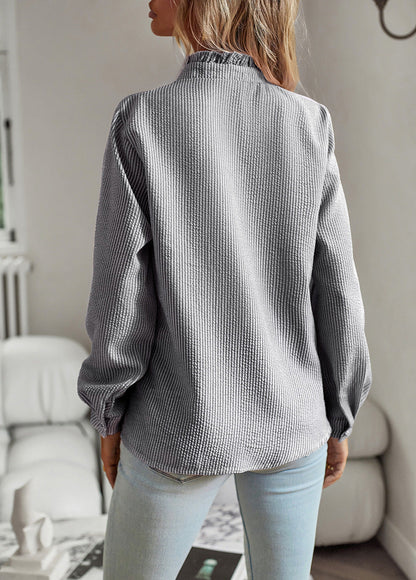 Women's blouse with ruffle accents and clean button front