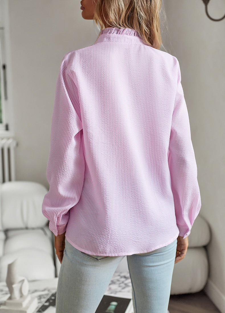 Women's blouse with ruffle accents and clean button front